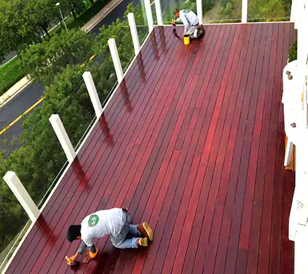 Painter Varnishing a Deck